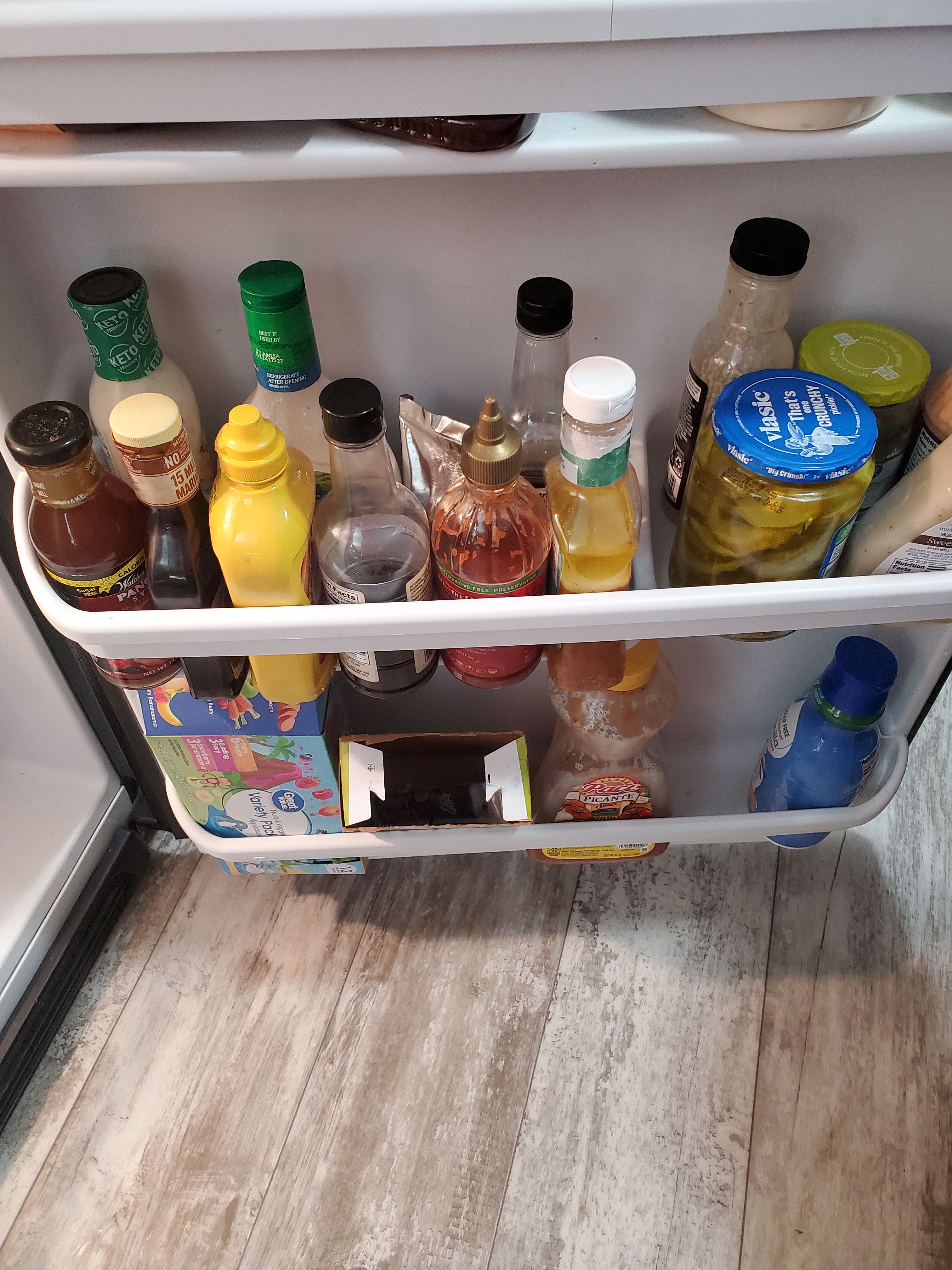 Side of fridge with various ingredients.